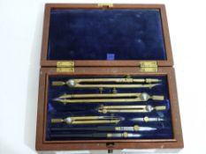 Mahogany cased drawing instruments, the hinged lid with lift up velvet padded compartment, beneath