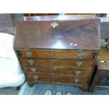 George III mahogany bureau with fall front opening to a fitted interior over three long drawers