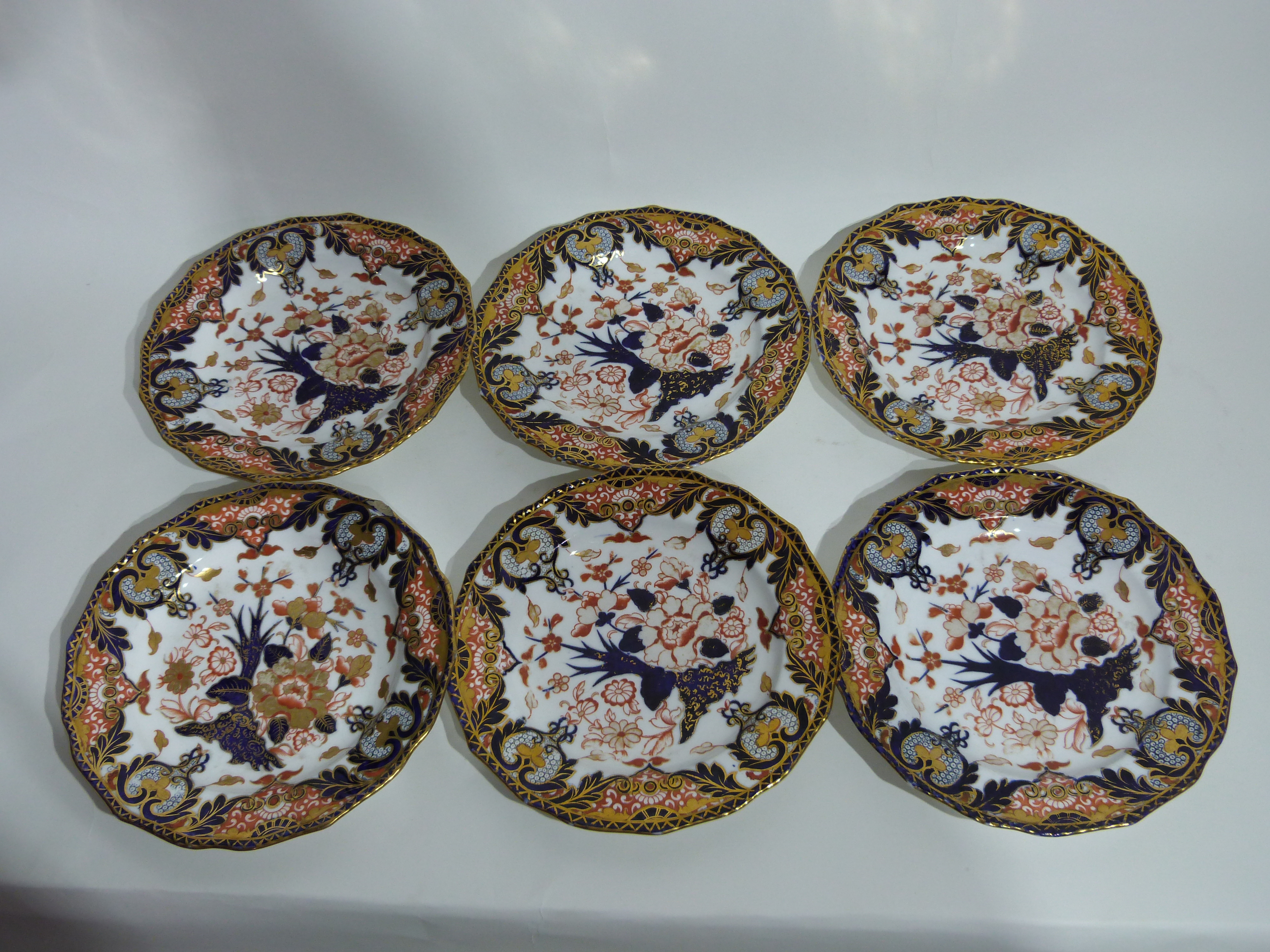 Set of 12 19th century Crown Derby plates all with typical Imari designs in blue, gilt and red,