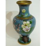 Cloisonne vase decorated in typical fashion with flowers on blue and gilt ground, 23cm high