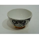 Small bowl decorated in black and white with a design by Fornicetti, with a gilt line below, the