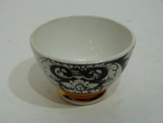 Small bowl decorated in black and white with a design by Fornicetti, with a gilt line below, the