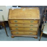 George III faded mahogany bureau with fall front opening to a shelved interior over four long