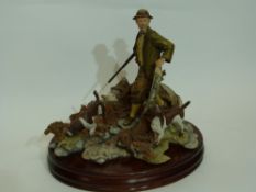 Large Sherratt & Simpson model of a gamekeeper with dogs, the model mounted on a large oval base,