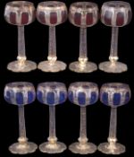 Group of eight wine goblets decorated in Bohemian style with blue and amber flashing, the shaped