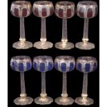 Group of eight wine goblets decorated in Bohemian style with blue and amber flashing, the shaped