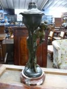 Bronze spelter table lamp base formed as a female figure, raised on a circular red marble base,