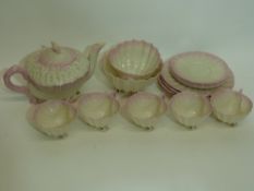 Early 20th century Belleek tea set moulded in shell form, comprising tea pot, milk jug and sugar