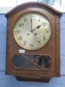 Early 20th century oak cased wall clock fitted with brass movement striking on a coiled gong, case