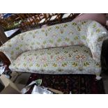 Early 20th century three-seater floral upholstered sofa raised on short turned wooden legs with