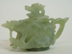 Green soapstone Chinese tea pot, modelled in relief with dragons and dragon finial, 9cm high