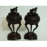 Pair of Oriental censers on oval stands, the censers raised on three elongated feet, the covers with