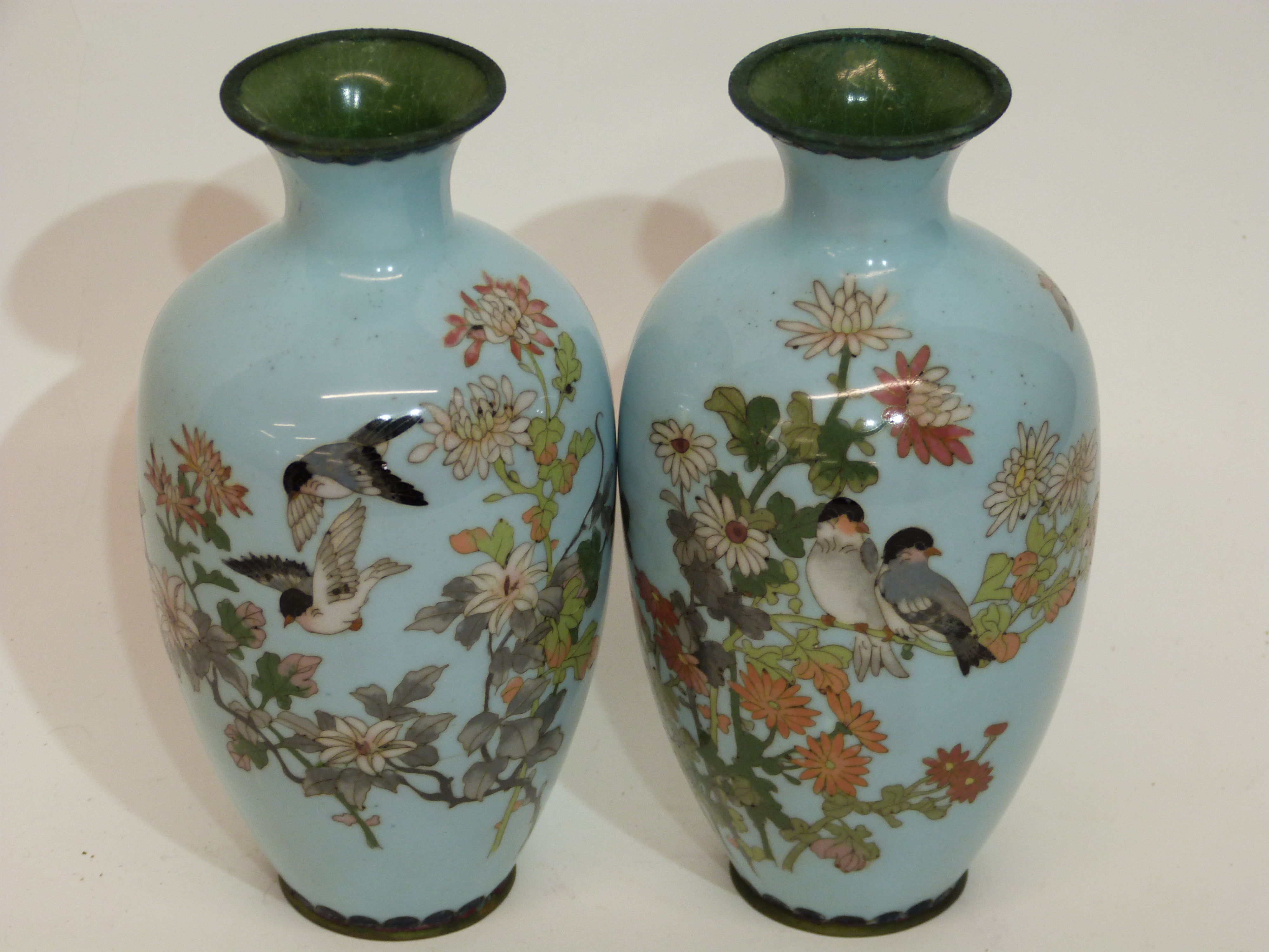 Pair of Japanese cloisonne vases, Meiji period, the light blue ground decorated with foliage and