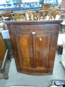 19th century mahogany corner cabinet of large proportions, the bow front body with two panelled