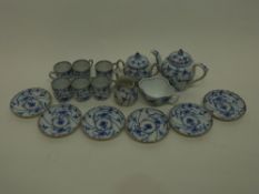 Miniature tea set with a blue design in Meissen style comprising small tea pot, sucrier and cover,