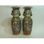 Pair of 19th century Cantonese vases decorated in famille rose style, with panels of figures and