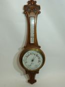 W Norris, Saxmundham, a late 19th century oak cased aneroid barometer and thermometer combination