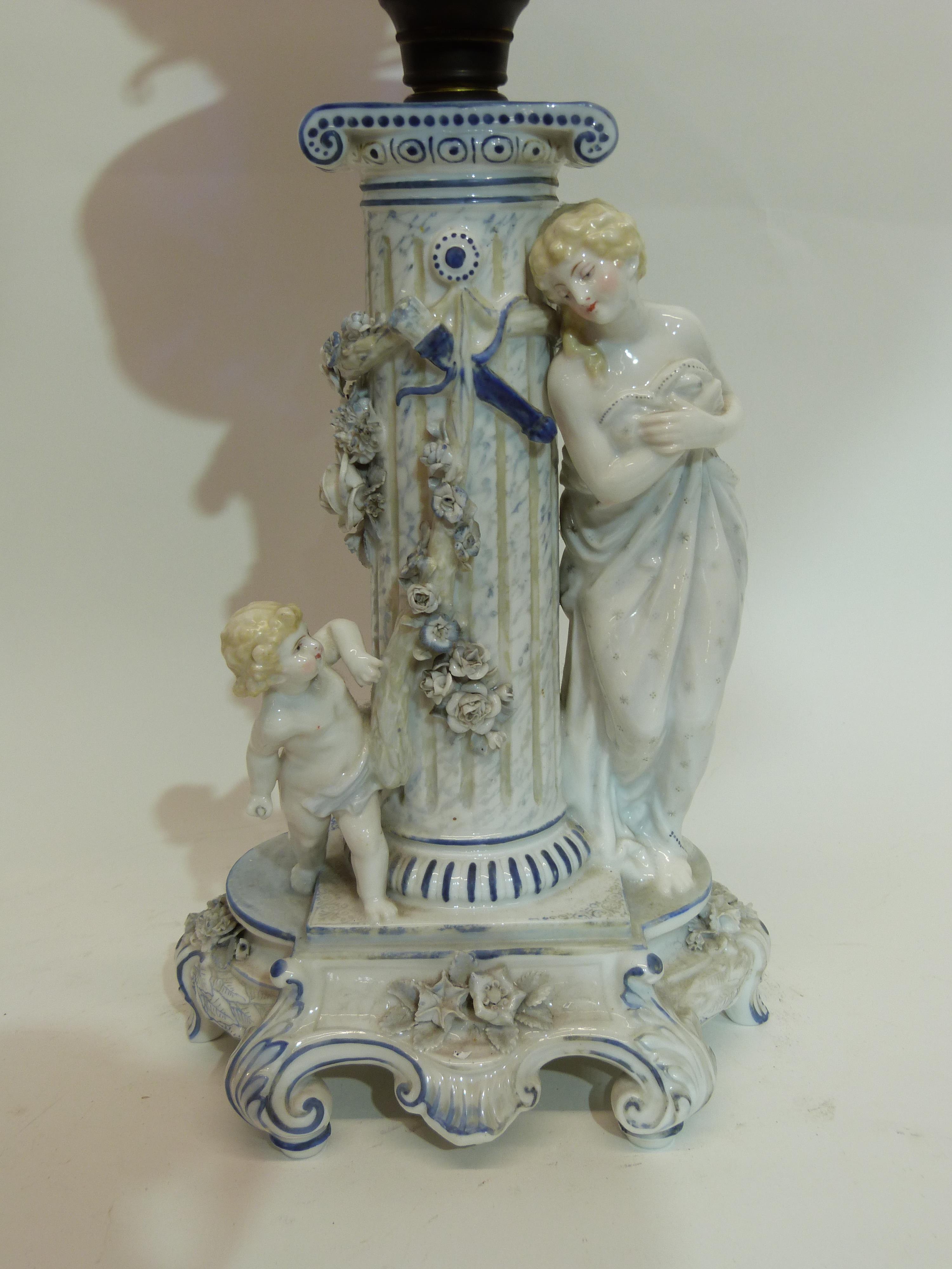 Oil lamp with blue glass reservoir below a white glass floral shade, supported by a porcelain column - Image 2 of 3