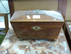 19th century mahogany and inlaid sarcophagus formed tea caddy, the hinged lid opening to a fitted