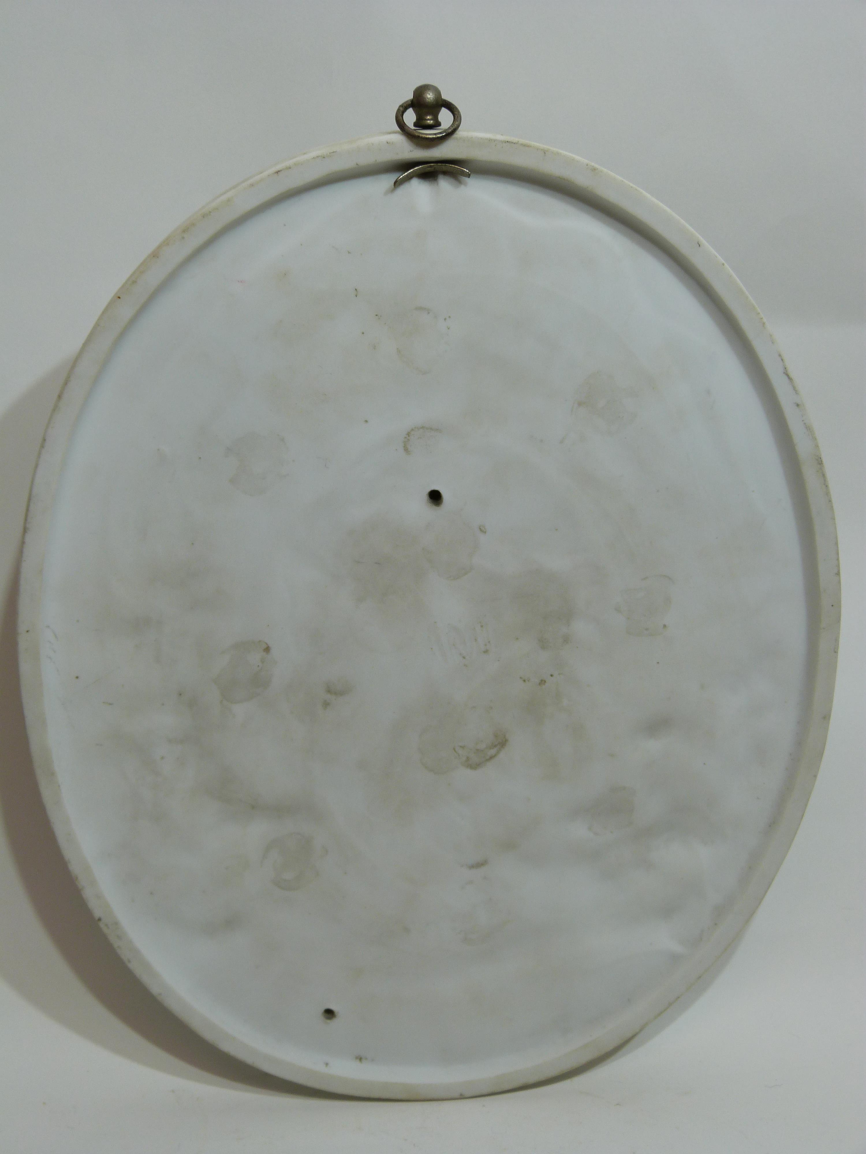 Oval porcelain plaque modelled in relief with two figures against a floral background, 23cm long - Image 2 of 2