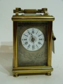 Late 19th century carriage clock with white enamel dial, Roman numerals, surrounded by chased silver