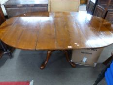 Good quality reproduction cherry wood dining table, the oval planked top set on a heavy turned