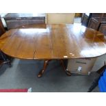 Good quality reproduction cherry wood dining table, the oval planked top set on a heavy turned