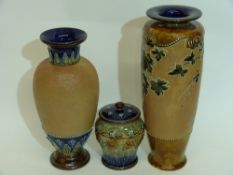 Group of Doulton wares including a tobacco jar with tube lined design and two vases, one with a