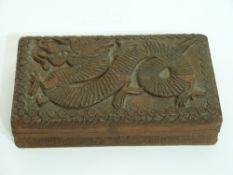 Chinese wooden hinged box, the top carved with a dragon in relief, 20cm wide