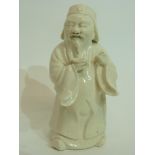 Unusual white pottery glazed figure of a Chinese deity, 15cm high
