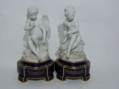 Pair of Sevres style bisque porcelain models of an angel and a young girl seated on rock work,