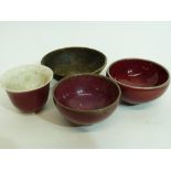 Group of small Oriental bowls with a flambe glaze and further bronze bowl decorated in relief with