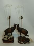 Two table lamps both wooden models of deer on rocky bases