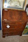 REPRODUCTION MAHOGANY BUREAU WITH FALL FRONT, FITTED INTERIOR OVER FOUR DRAWERS RAISED ON BRACKET