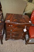 REPRODUCTION FLAME MAHOGANY VENEER SERPENTINE FRONT CHEST OF FOUR DRAWERS RAISED ON BRACKET FEET,