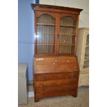 EARLY 20TH CENTURY OAK BUREAU BOOKCASE CABINET, THE TOP SECTION WITH TWO GLAZED DOORS OVER A BASE