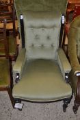 LATE VICTORIAN GREEN UPHOLSTERED ARMCHAIR WITH EBONISED FRAME