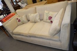 CREAM UPHOLSTERED THREE SEATER SOFA WITH LOOSE CUSHIONS