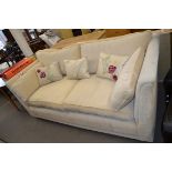 CREAM UPHOLSTERED THREE SEATER SOFA WITH LOOSE CUSHIONS