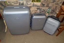 THREE GREY HARD PLASTIC WHEELED SUITCASES