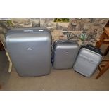 THREE GREY HARD PLASTIC WHEELED SUITCASES