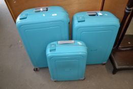 THREE HARD PLASTIC WHEELED SUITCASES