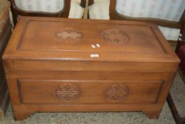 MODERN CHINESE CAMPHOR WOOD BLANKET BOX OF HINGED RECTANGULAR FORM DECORATED WITH CARVED DETAIL,