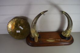 BRASS TABLE GONG WITH COW HORN SUPPORTS AND POLISHED OAK BASE