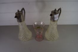 TWO CLEAR GLASS CLARET JUGS WITH SILVER PLATED MOUNTS TOGETHER WITH A PINK GLASS VASE