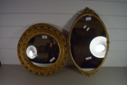 TWO MID CENTURY WALL MIRRORS, ONE IN AN OVAL FRAME, THE OTHER IN A CIRCULAR FRAME WITH GILT FLORAL