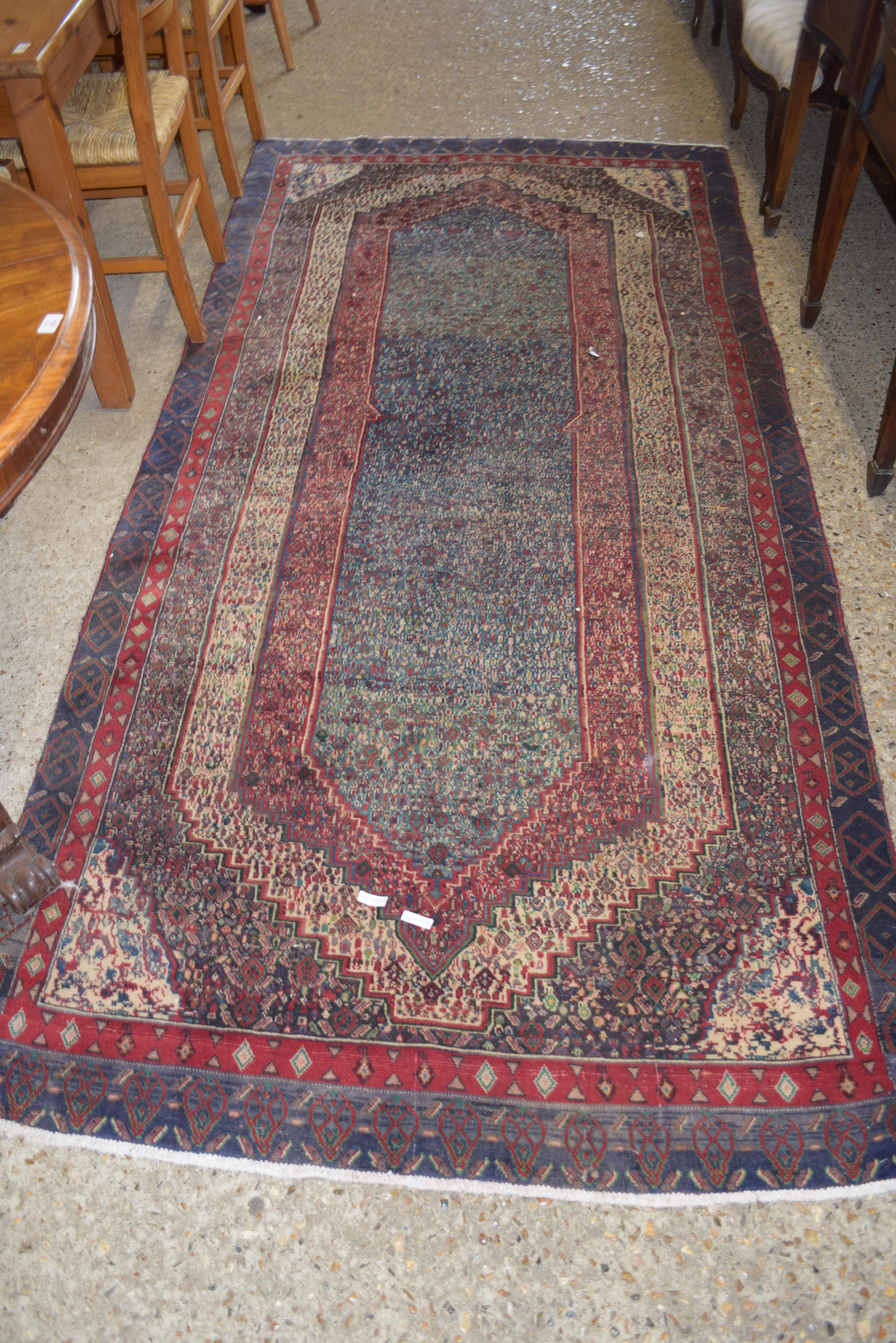 MODERN WOOL FLOOR RUG DECORATED WITH LARGE CENTRAL PANEL ON A PRINCIPALLY RED AND BLUE BACKGROUND,