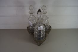 SILVER PLATED BOTTLE STAND AND THREE ACCOMPANYING CUT GLASS DECANTERS