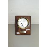 ELGIN FOUR JEWEL BRASS CASED SHIPS BULKHEAD CLOCK ON A HARDWOOD BACK WITH PRESENTATION INSCRIPTION