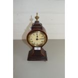 EARLY 20TH CENTURY GERMAN MANTEL CLOCK SET IN A MAHOGANY BALLOON SHAPED CASE WITH BRASS FINIAL